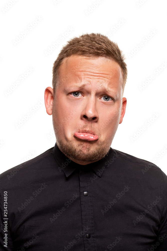 Close up portrait of a confident, blond, handsome young man wearing black shirt, isolated on white background Close up portrait of a confident, blond, handsome young man wearing black shirt, isolated on white background