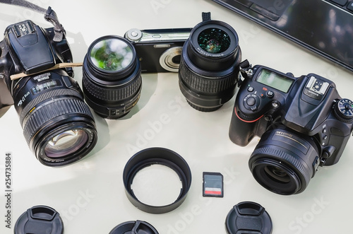 image of outdoor photographic equipment on a white table with natural light with assorted lenses photo
