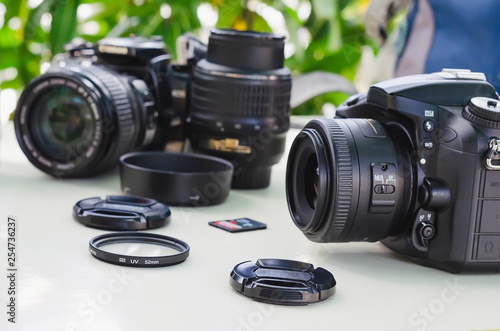 image of outdoor photographic equipment on a white table with natural light with assorted lenses photo