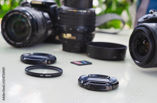 image of outdoor photographic equipment on a white table with natural light with assorted lenses