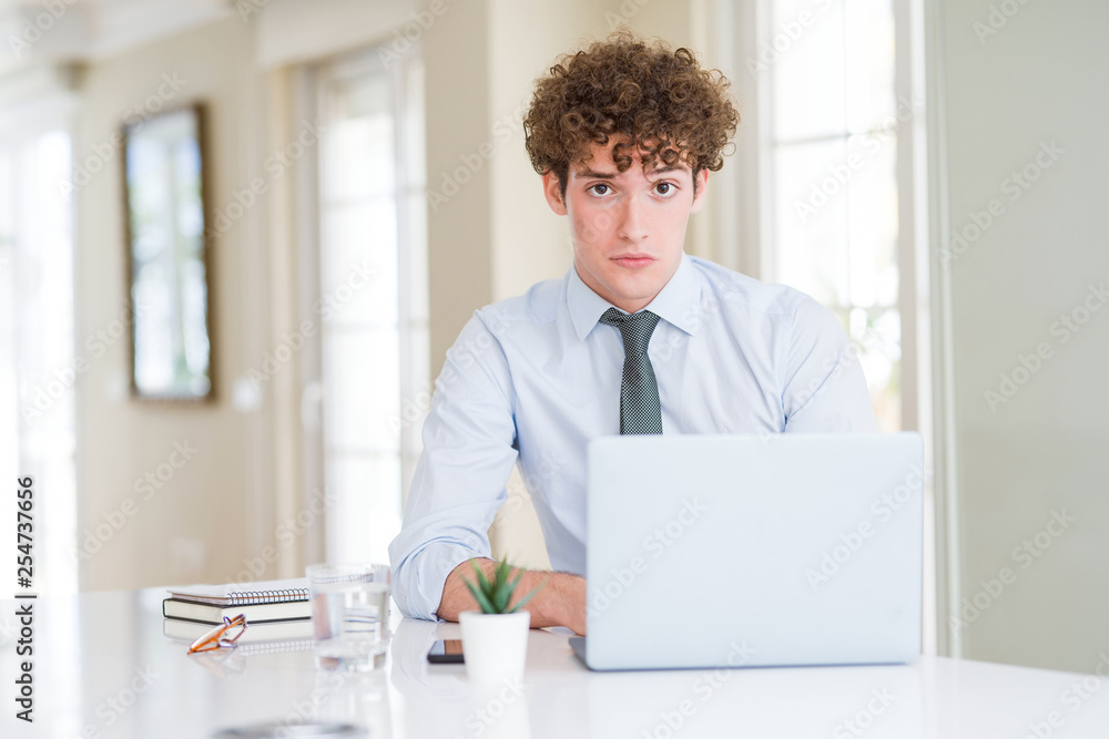 Young business man working with computer laptop at the office depressed and worry for distress, crying angry and afraid. Sad expression. Young business man working with computer laptop at the office depressed and worry for distress, crying angry and afraid. Sad expression.
