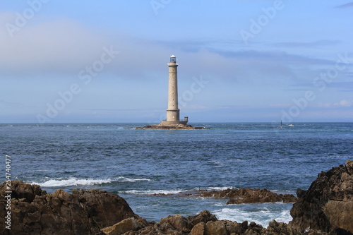 a coast landscape with the lighthouse of cap de la hague in the sea in normandy, france in summer