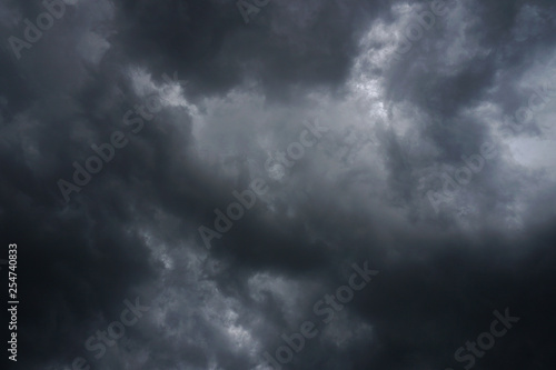 Dark  grim  stormy  rainy sky with rays of light. Scary hurricane clouds. Natural element. Stock Photo for your design