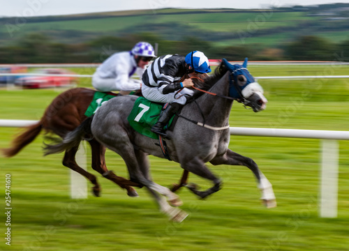 Jockey and race horse in competing in a race, speeding fast motion blur