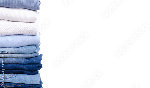 Stack blue jeans and clothes on white background isolation