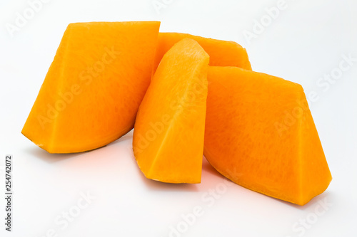 Pieces of fresh pumpkin isolated on white background. Close-up.
