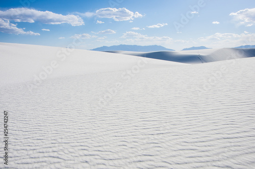 White sand dunes and blue cloudy sky in New Mexico desert