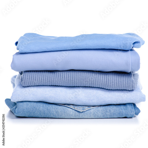 Stack blue clothes and jeans on white background isolation
