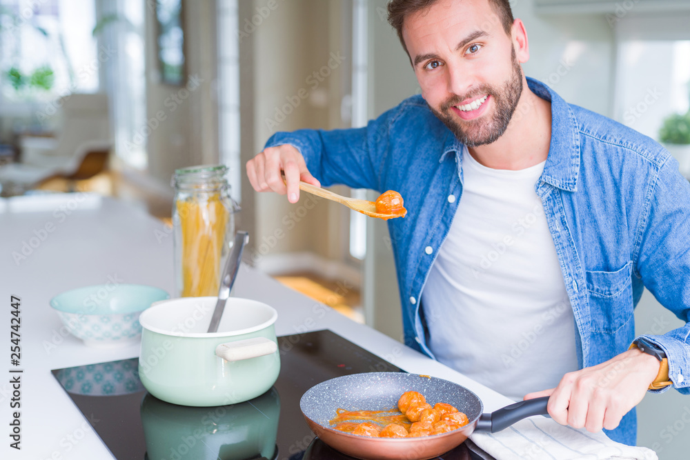 Handsome man cooking pasta at home Handsome man cooking pasta at home