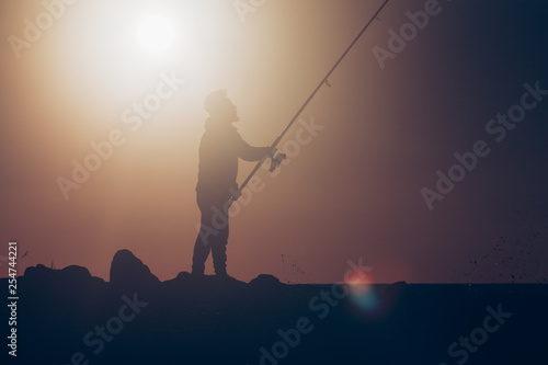 Fisherman fishing during hot summer day