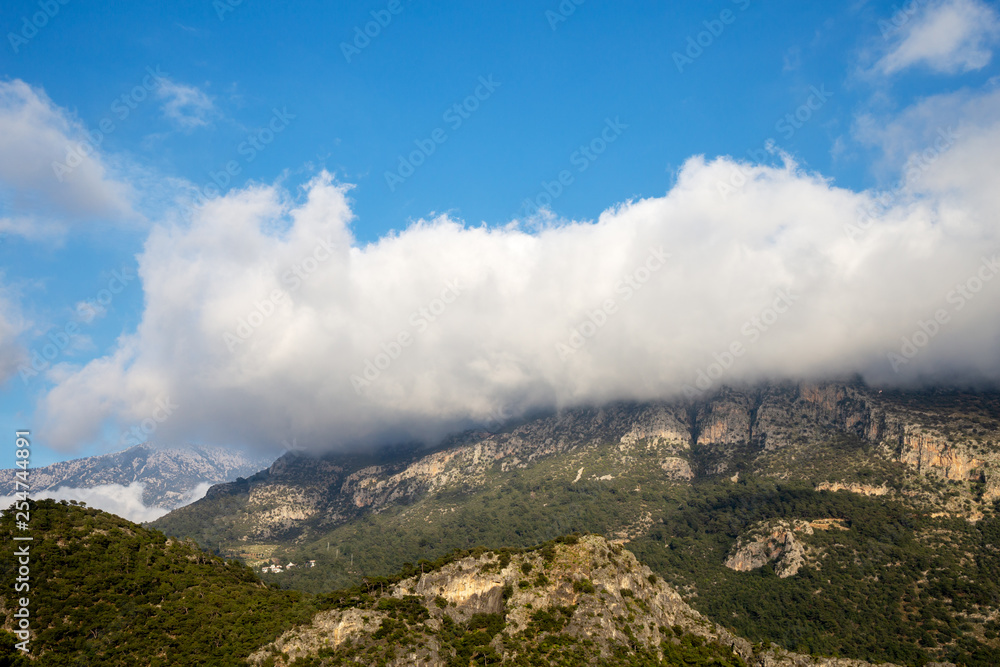 Green mountain covered by cloudy sky. Fethiye, Mugla, Turkey.
