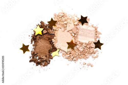A broken neutral colored eye shadow make up palette isolated on a white background. Top view, flat lay. Copy space for your text