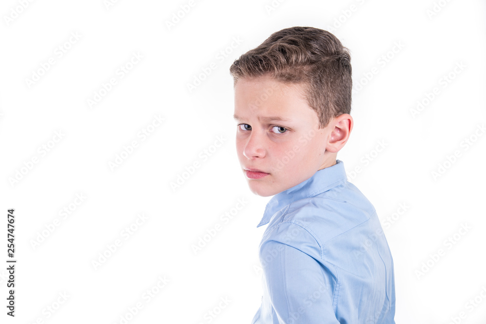 chic dressed boy in blue shirt looks critically over shoulder chic dressed boy in blue shirt looks critically over shoulder