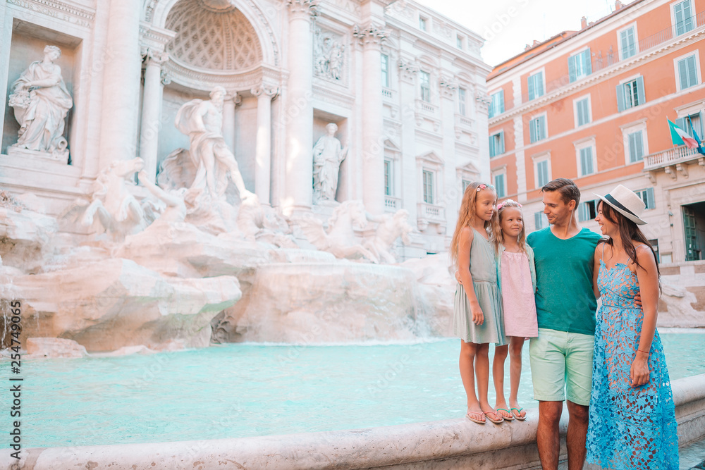 Happy family near Fontana di Trevi with city map