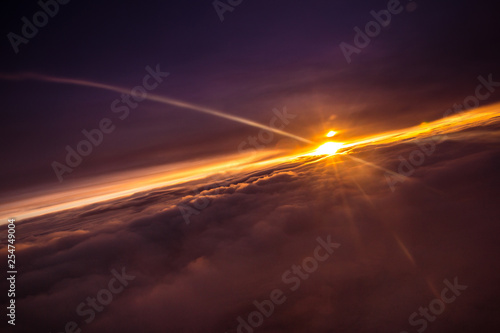 Beautiful and colorful sunset above the clouds