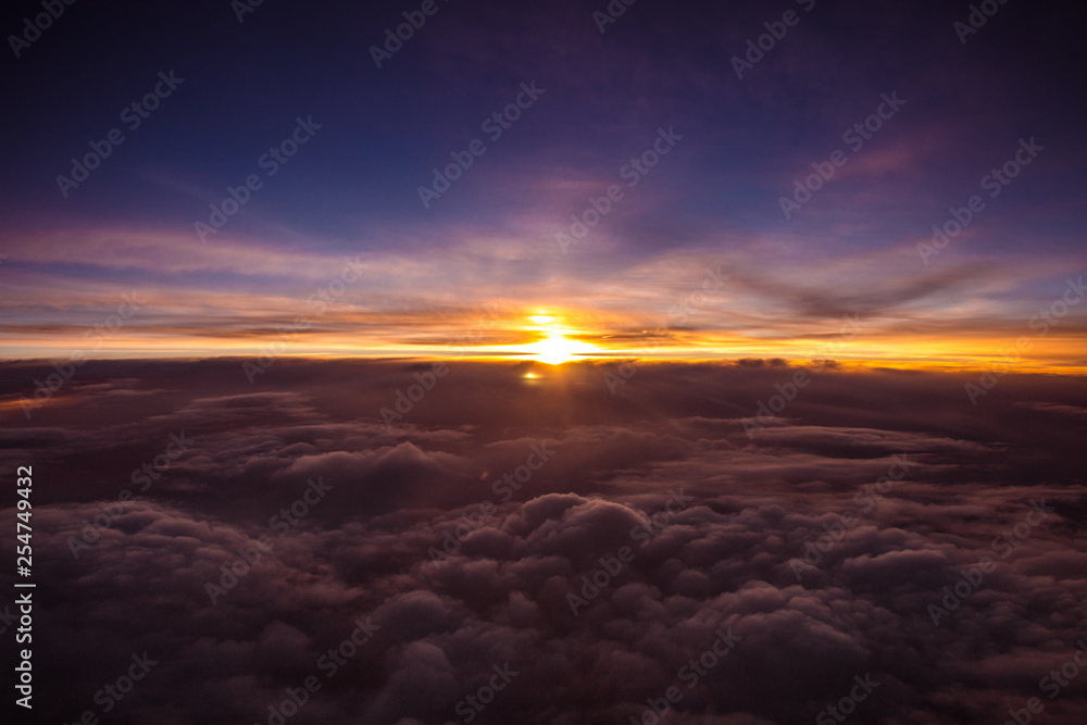 Beautiful and colorful sunset above the clouds