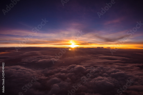 Beautiful and colorful sunset above the clouds