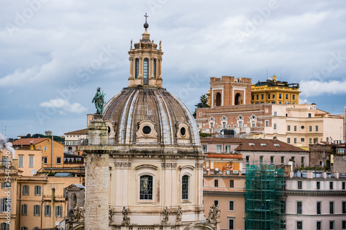 Trajan's column and dome of The Church of the Most Holy Name of Mary at the Trajan Forum in Rome, Italy