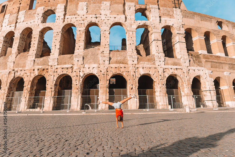 Little girl in front of colosseum in rome, italy