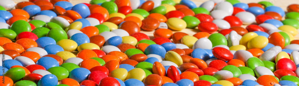 colorful chocolate candies on wooden background colorful chocolate candies on wooden background