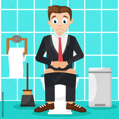 Man sitting on the toilet in the bathroom. Indigestion.