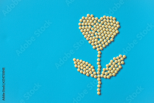 Assorted pharmaceutical medicine pills, tablets and capsules and bottle on purple background. Drugs and various narcotic substances. Copy space for text. Stock photo for design