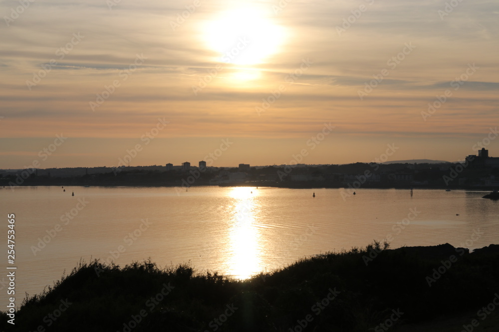 Plymouth dry sun, United Kingdom. View of the sun reflected on the sea.
