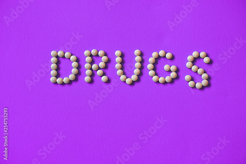 Assorted pharmaceutical medicine pills, tablets and capsules background.lined inscription from the tablets of narcotic substances. Text of the drug warning. Stock photo for design