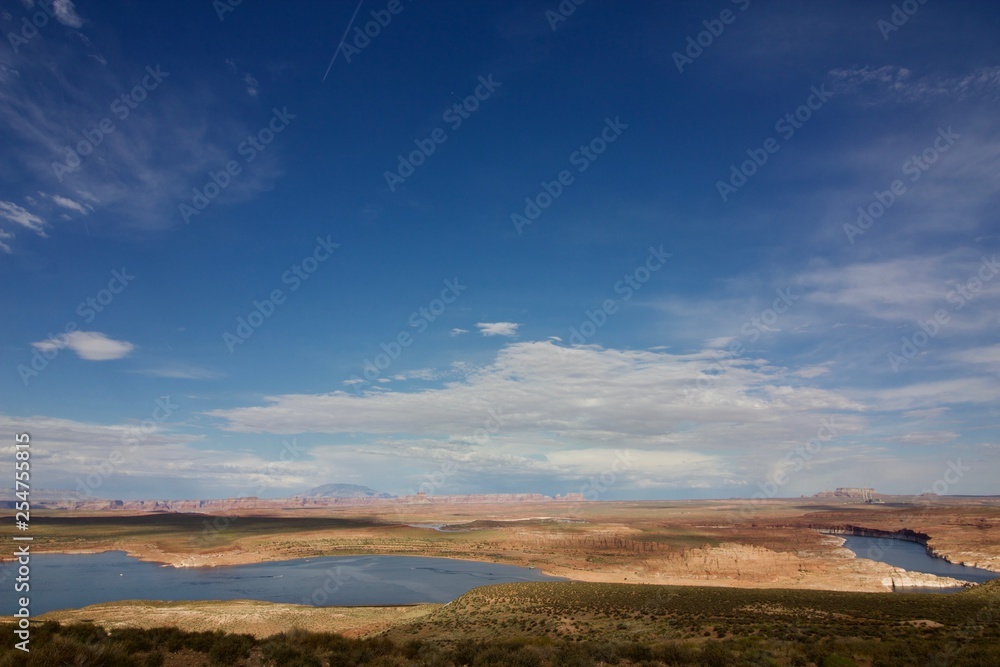 Lake in the Desert in Utah, USA. Blue sky with gigantic clouds over the canyon background.