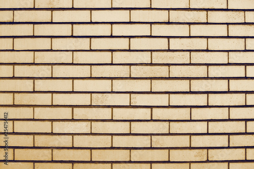 Old beige brick wall background