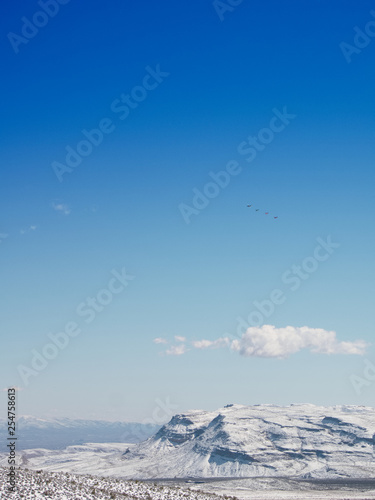 Snow in the desert of Las Vegas with mountains in the distance and lots of blue sky, vertical orientation