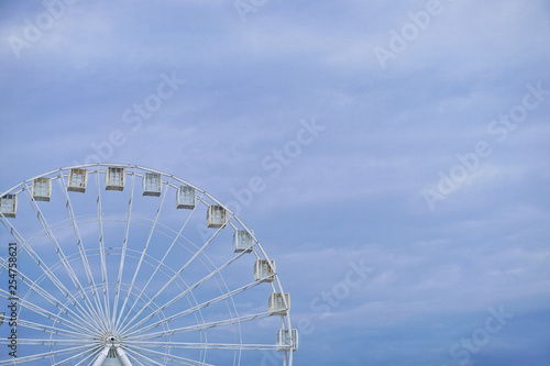 White ferris wheel on a blue sky background. Place for text. Stock Photo