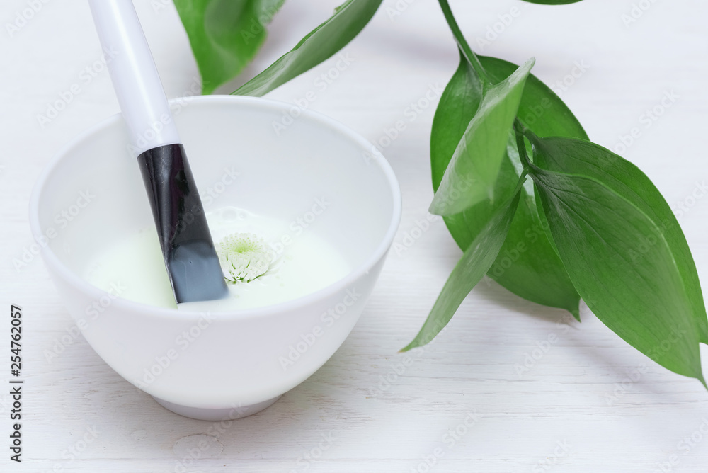 Natural cosmetic face mask in a jar on a white table background. Natural cosmetic face mask in a jar on a white table background.