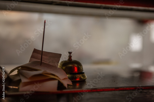 Tickets and a bell wait in a food window