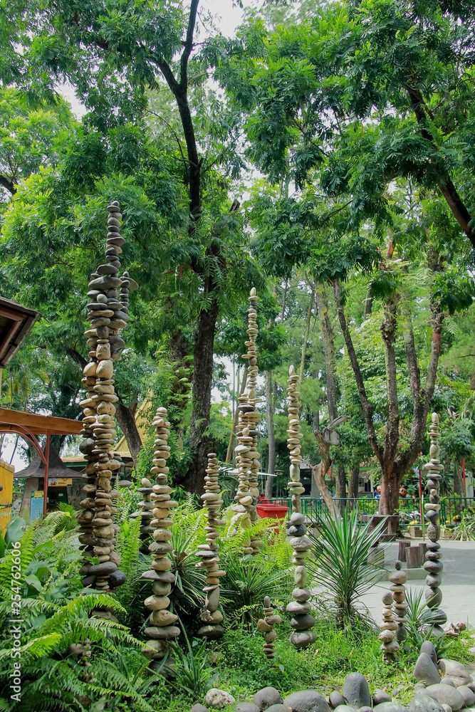 Fototapeta premium tall balanced stone pyramide on gembiraloka zoo