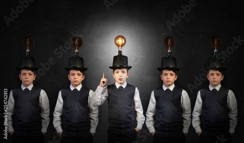 Canvas Print Excellent idea, kid with edison bulb above his head atanding out of the crowd