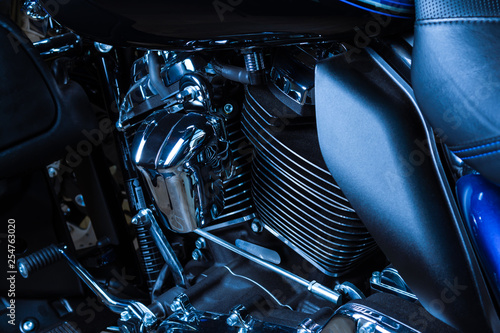Motorcycle internal combustion engine with air cooling, close-up, detail, macro. Engine parts, cylinder head, ignition, exhaust pipe, air-intake manifold