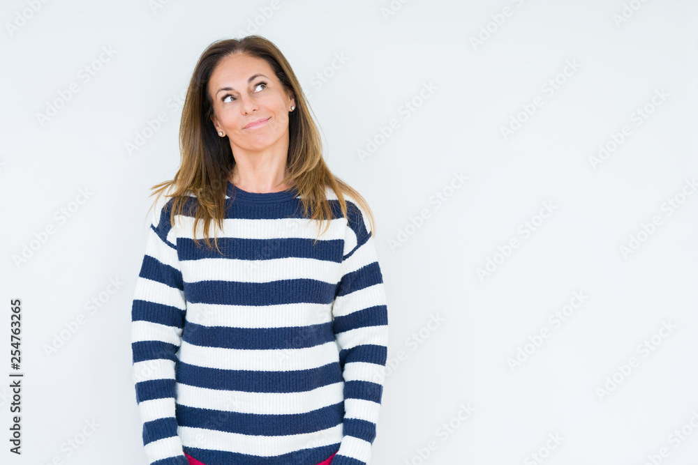 Beautiful middle age woman wearing navy sweater over isolated background smiling looking side and staring away thinking. Beautiful middle age woman wearing navy sweater over isolated background smiling looking side and staring away thinking.
