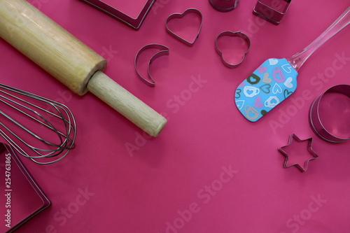 baking utensils on pink background