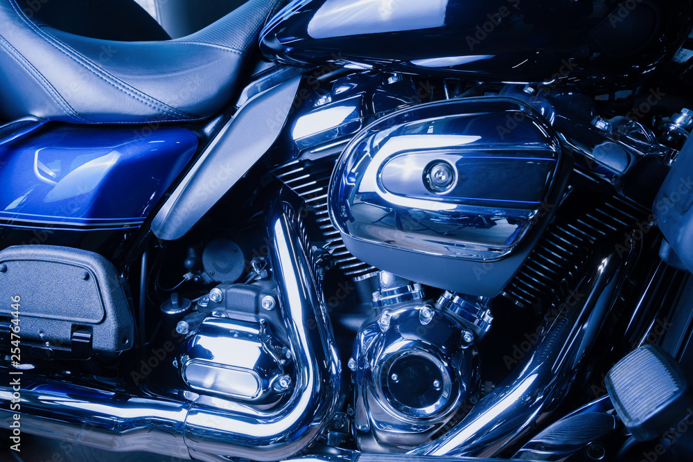 Motorcycle internal combustion engine with air cooling, close-up, detail, macro. Engine parts, cylinder head, ignition, exhaust pipe, air-intake manifold Motorcycle internal combustion engine with air cooling, close-up, detail, macro. Engine parts, cylinder head, ignition, exhaust pipe, air-intake manifold