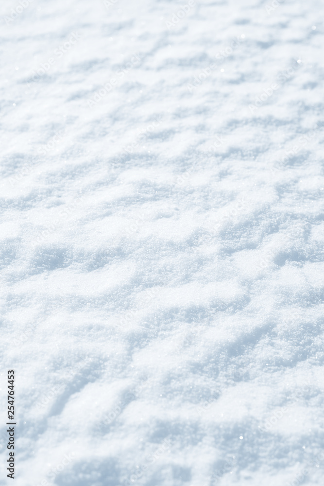 Fresh snow background texture. Winter background with snowflakes and snow mounds. Snow lumps.