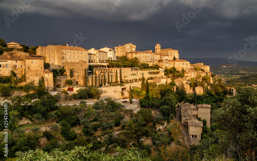 Amazing panoramic view of medieval hilltop village of Gordes before thunderstorm in Provence, France. Travel France.