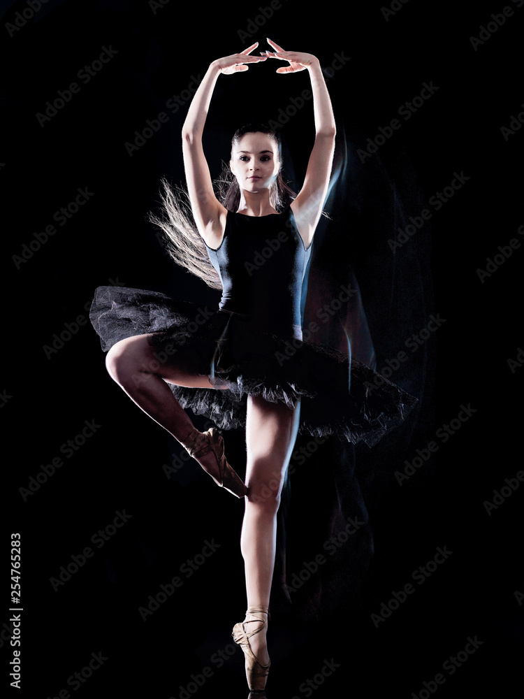 Fototapeta premium one caucasian young woman ballerina dancer dancing isolated on black background with light painting motion blur speed effect