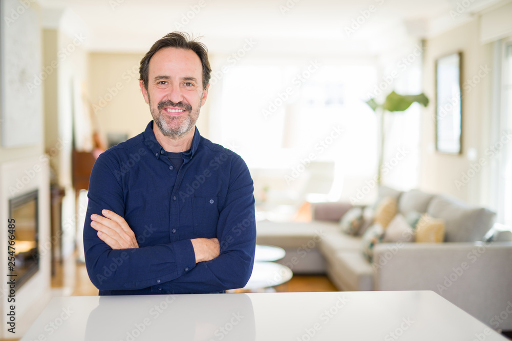 Handsome middle age man at home happy face smiling with crossed arms looking at the camera. Positive person. Handsome middle age man at home happy face smiling with crossed arms looking at the camera. Positive person.