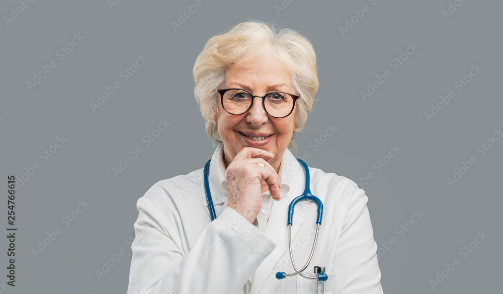 Senior female doctor posing and smiling Senior female doctor posing and smiling
