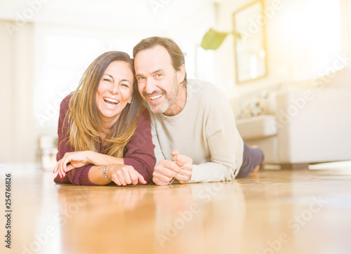 Beautiful romantic couple sitting together on the floor at home