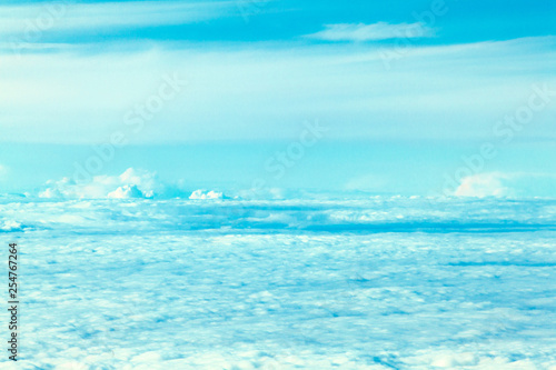 Airplane flying in the blue sky among white clouds © Mike Orlov