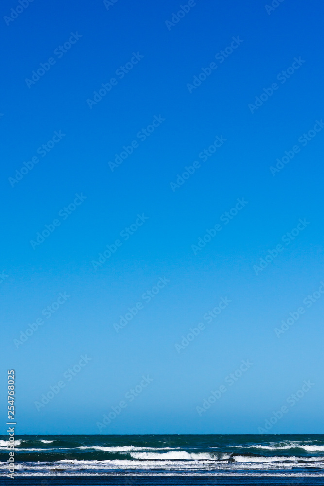 minimalist seascape with blue water and blue sky