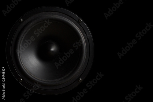 Black Music speaker on a black isolated background. Party or music listening concept.