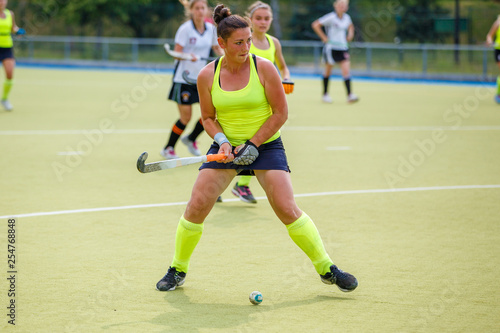 Young hockey player woman with ball in attack